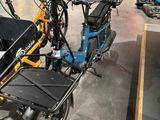 un vélo bleu et jaune avec un coffre à l'arrière