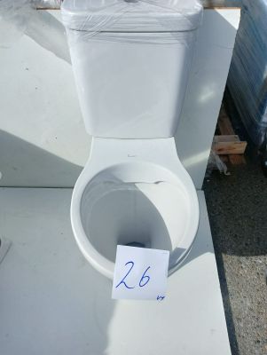 a white toilet sitting on a table with a price tag