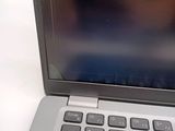 a close up of a laptop on a white table