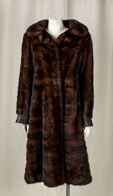 an image of a woman ' s fur coat on a mannequin stand