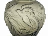 a glass vase with a design on it on a white surface