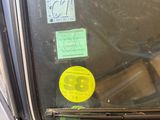 a close up of a car window with stickers on it