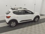 the white car is parked in the garage with its roof rack on