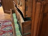a wooden dresser with a drawer on top of it