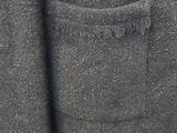 the back of a black jacket with a pocket on it