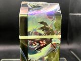 pokemon trading card game box on display in a glass case