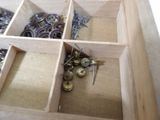 a wooden box with a bunch of screws inside of it