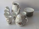 a white table with a lot of cups and saucers
