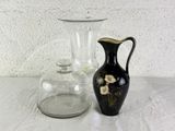 two vases sitting on a table next to each other