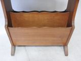a wooden magazine rack with a magazine holder on top of it