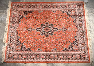an orange and black rug with a medallion design on it