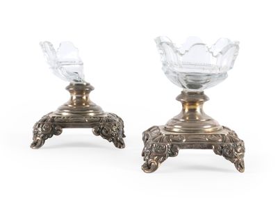 paire de bougeoirs en métal argenté avec des vases en cristal taillé posés sur des socles