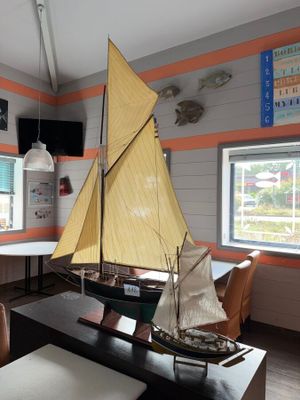 a model sailboat sitting on a table in a room