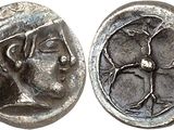 a silver coin with an image of a man and a woman on it