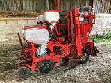 a red tractor that is sitting in the dirt