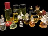 many different bottles of perfume on a black background
