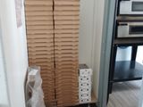 a stack of cardboard boxes in the corner of a room