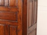 a wooden cabinet with a door on top of it