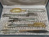 five different types of knives in a silver case