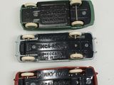 three different types of toy trains on a white surface