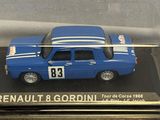 a blue toy car in a clear case on a table