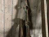 some old tools are sitting on a wooden table in a room