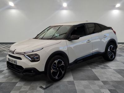 the white car is parked in a large room with checkered floor
