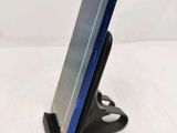 a cell phone that is on a stand on a table