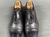 pair of men ' s leather shoes with laces on the toes