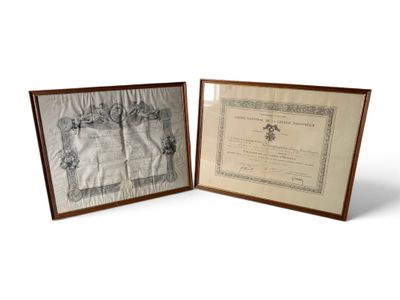 two framed pictures of a certificate and a certificate on a table