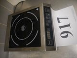 a black and silver stove top with a sign on it