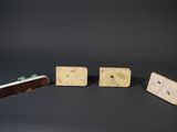 three pieces of cheese are arranged in a row on a black surface