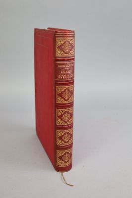 a red book that is sitting on a white surface