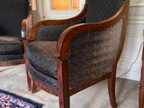 two chairs in a room with a rug on the floor