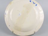 underside view of a plate with a blue and white design on it