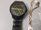 a watch that is laying on a table next to a string