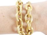 gold chain bracelet on a woman ' s arm