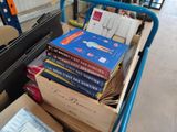 a cart full of books on the floor in a warehouse