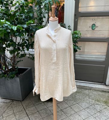 an image of a mannequin dress on a mannequin stand in front of a building
