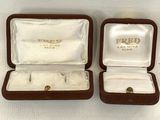 two pairs of gold rings in a box with a white background