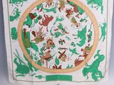 an image of a green and white scarf with animals on it
