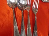 silverware on a table with a red cloth