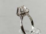a close up of a silver ring with a diamond in it