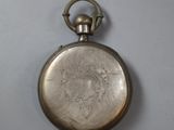 an old silver pocket watch with a chain hanging from it ' s side