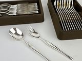 a box of forks and spoons sitting on a table