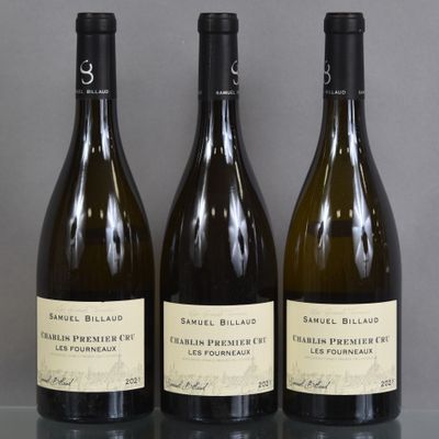 three bottles of wine are lined up on a table