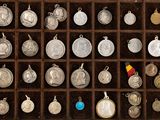 many different types of silver coins in a wooden box