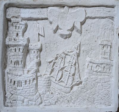 a relief of a ship in the water on the wall
