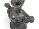 a statue of a woman holding a baby in a vase