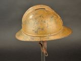 an old helmet on a stand against a gray background